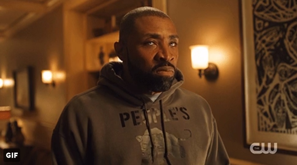 Jefferson Pierce (Cress Williams) wearing the dark grey People's Free Food Program hoodie.