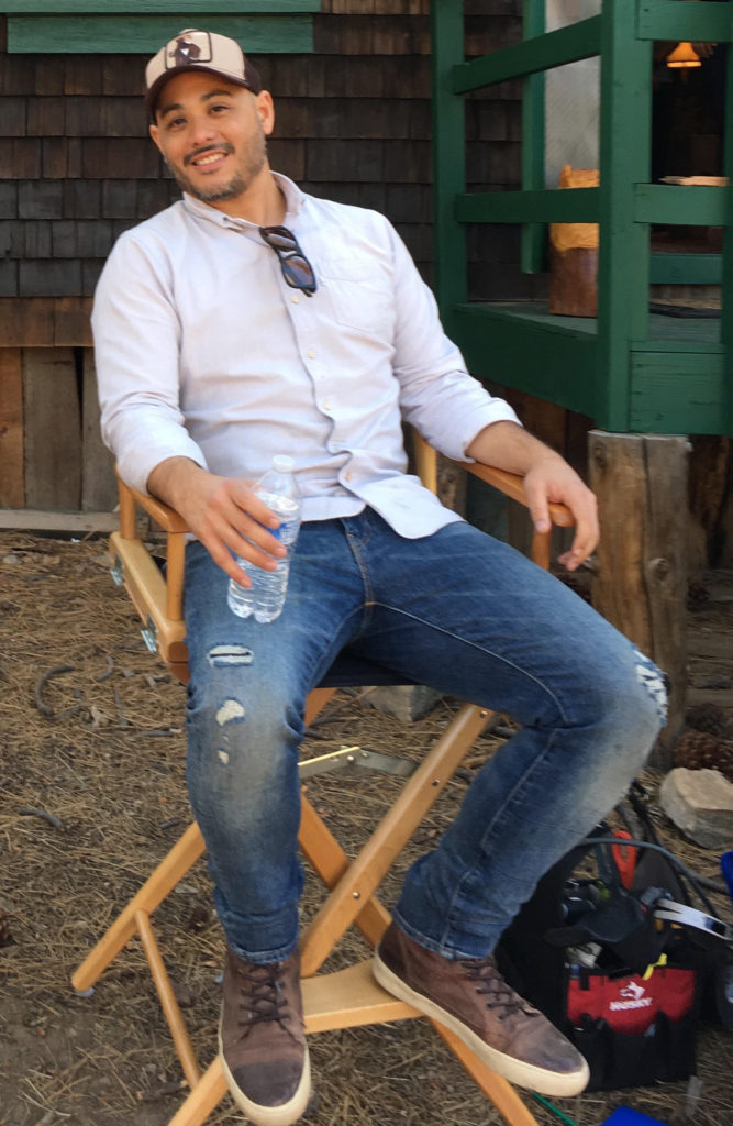 Patrick Green sitting in his director's chair outside