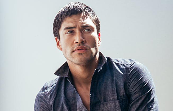 Martin Sensmeier in a denim shirt.