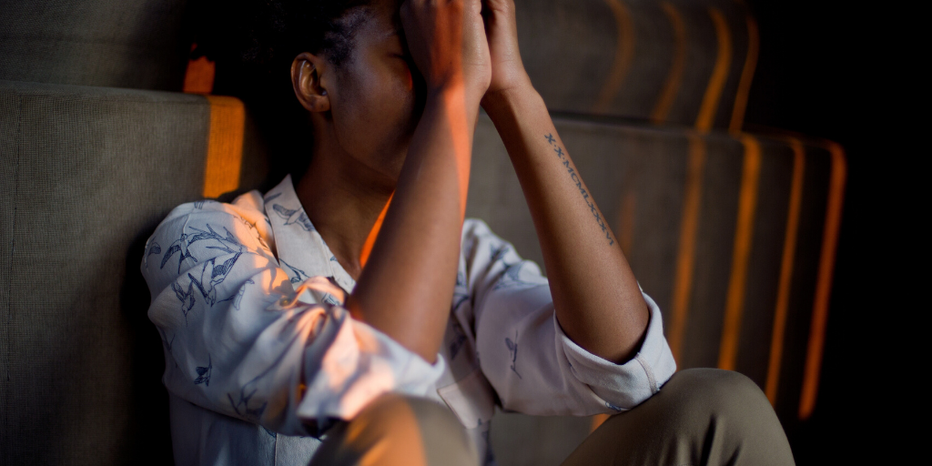 Social distancing can be hard on our mental health, but there are ways to keep ourselves going amid the struggle. Photo of stressed Black woman with hands in praying position in front of her face: Masimba Tinashe Madondo/Pixabay/Canva