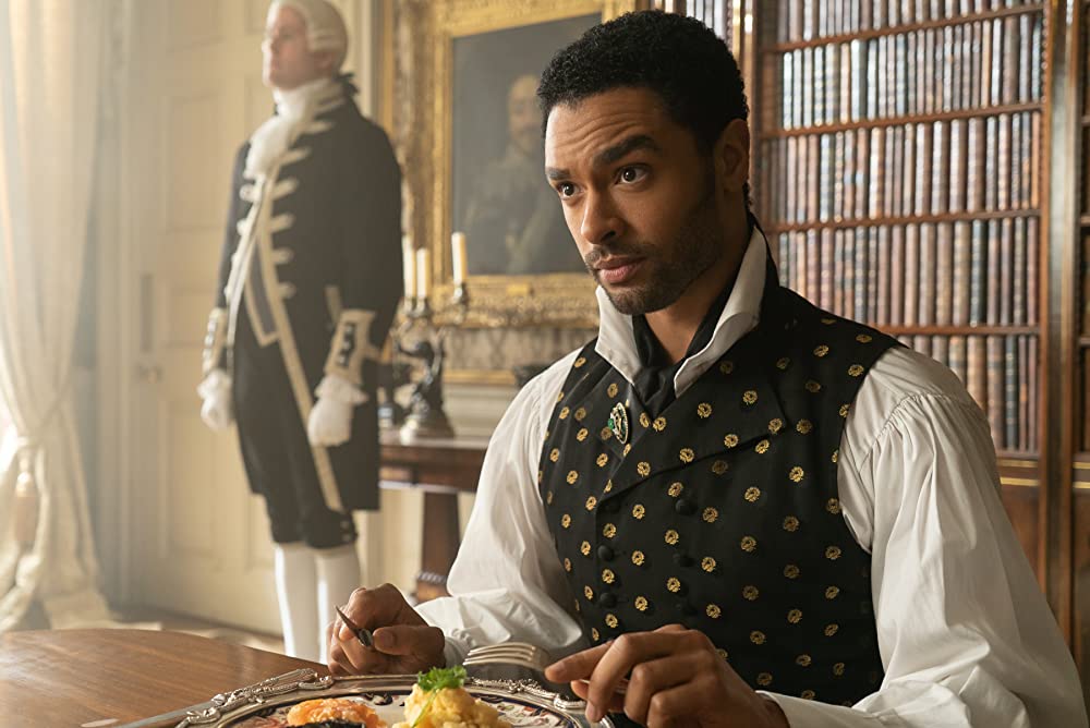 Simon (Regé-Jean Page) eating his Lordly meal. (Photo credit: Liam Daniel/Netflix)