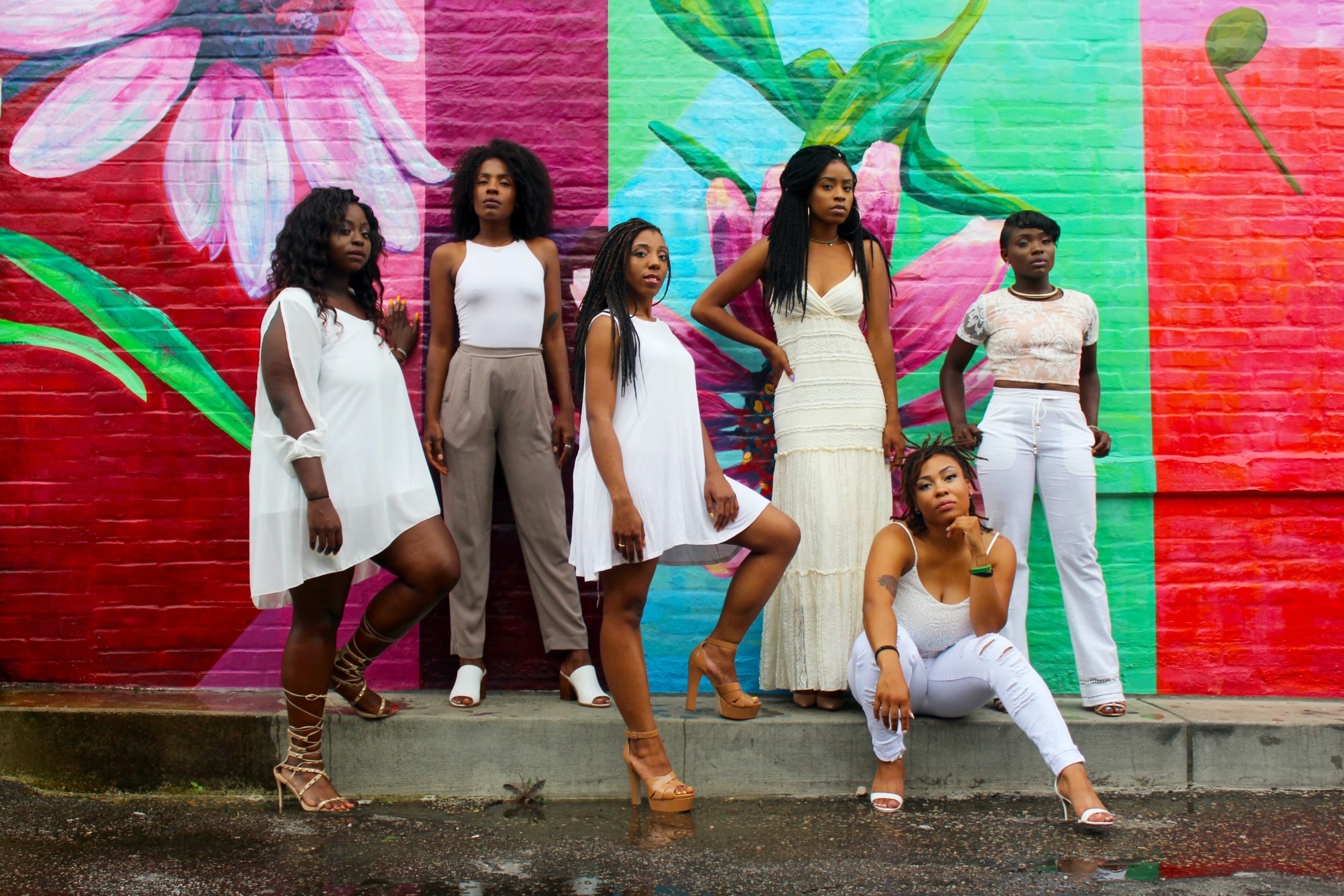 Photo of confident Black women in front of a colorful background by Clarke Sanders