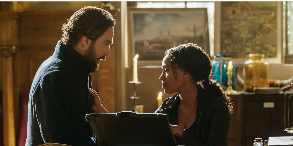 Abbie (Nicole Beharie) touches Ichabod's (Tom Mison) coat lapel. 