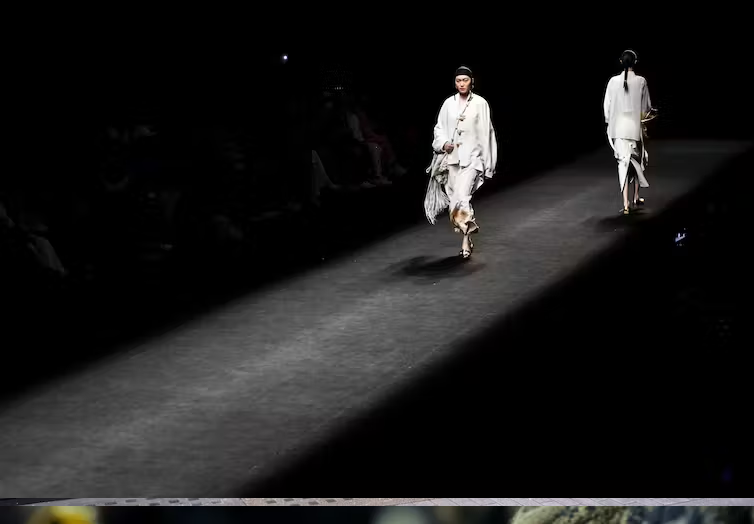 Models wearing outfits that reflect traditional Chinese culture walk the runway during China’s International Fashion Week in March 2023. VCG/Getty Images