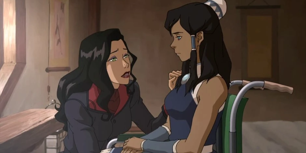 Asami kneels next to Korra, who is in a wheelchair. (Photo credit: Nickelodeon)