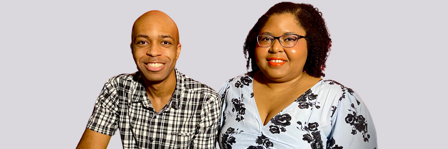 Julian and Monique are sitting together, smiling.