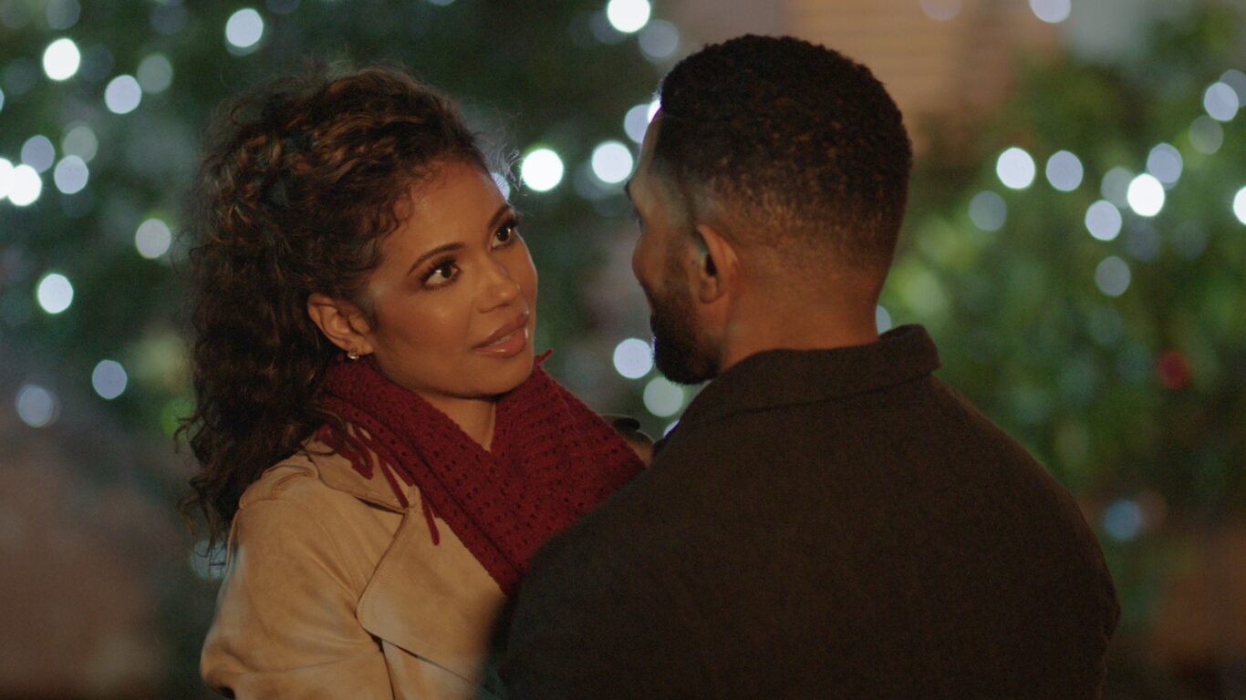 Jennifer Freeman and Anthony Dalton share a moment amid Christmas lights.