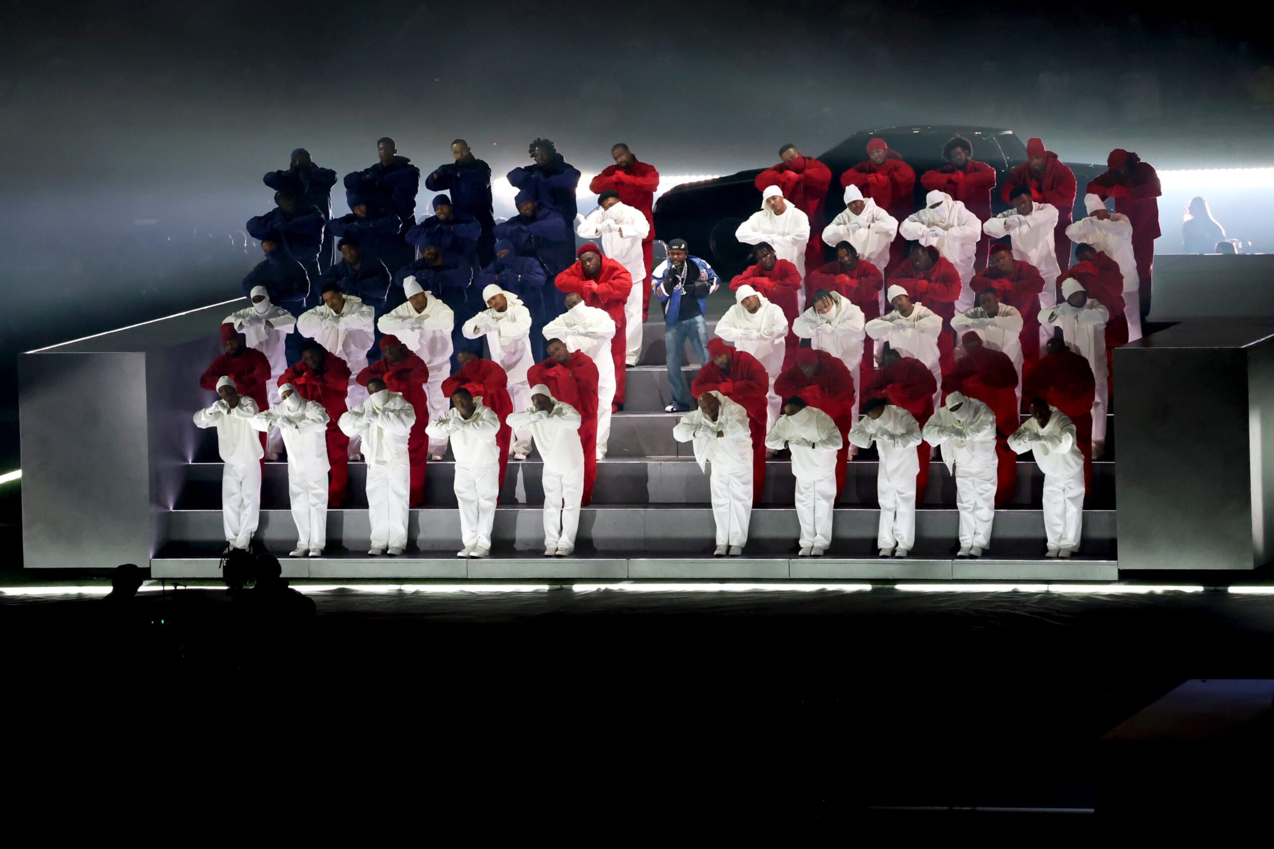 Kendrick Lamar among dancers wearing the colors (and in the formation of) the American flag.