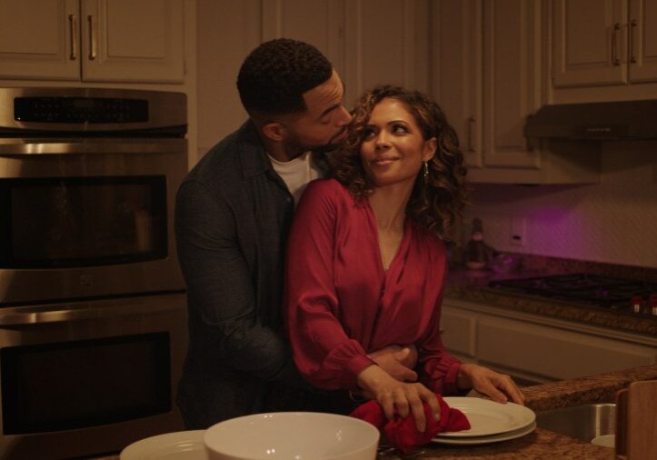 Jennifer Freeman and Anthony Dalton hug together in the kitchen.