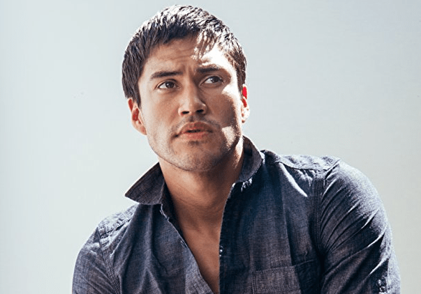 Martin Sensmeier in a denim shirt.