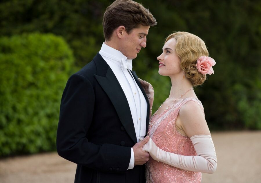 Downton Abbey Season 5 on MASTERPIECE on PBS

Part Seven
Sunday, February 15, 2015 at 9pm ET

Edith is found out. Mary finally shakes a suitor. Isobel and Lord Merton reveal their plans.
Robert throws another guest out of the house.

Shown from left to right: Matt Barber as Atticus and Lily James as Lady Rose

(C) Nick Briggs/Carnival Films 2014 for MASTERPIECE

This image may be used only in the direct promotion of MASTERPIECE CLASSIC. No other rights are granted. All rights are reserved. Editorial use only. USE ON THIRD PARTY SITES SUCH AS FACEBOOK AND TWITTER IS NOT ALLOWED.