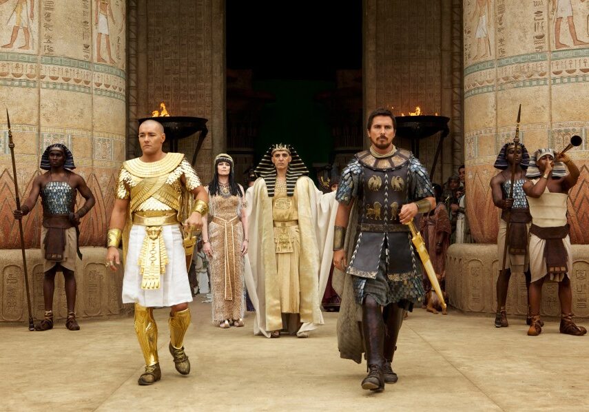 DF-00727R - Seti (John Turturro, background) presents the future leaders of Egypt: Ramses (Joel Edgerton, left) and Moses (Christian Bale).