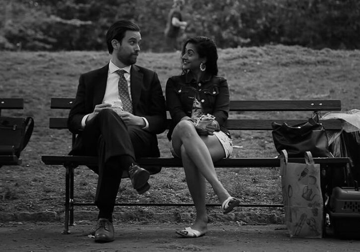 Justin Clark and Kavita Jariwala converse on a park bench.